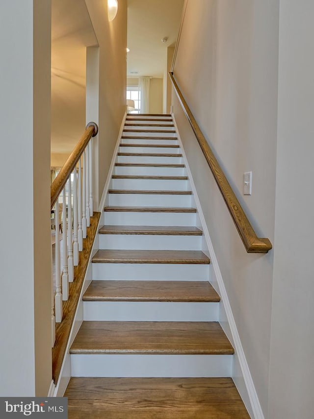 stairway featuring hardwood / wood-style floors