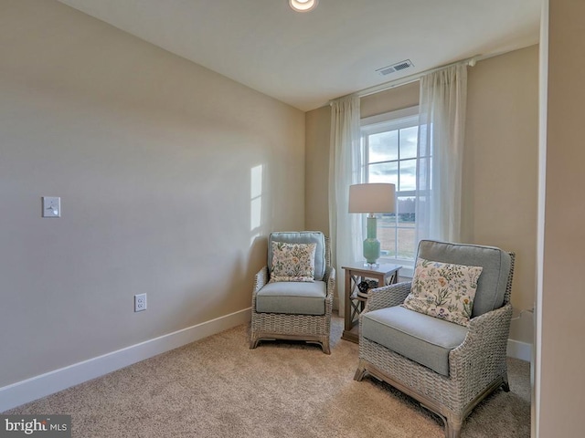 sitting room with light colored carpet