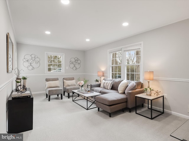 living area with light carpet, baseboards, a wealth of natural light, and recessed lighting