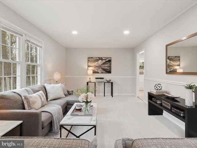 living area featuring light carpet, a healthy amount of sunlight, and recessed lighting