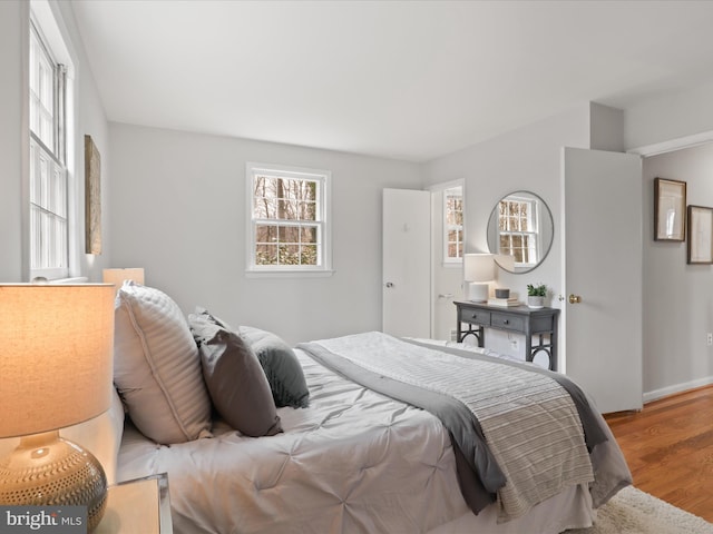 bedroom with baseboards and wood finished floors