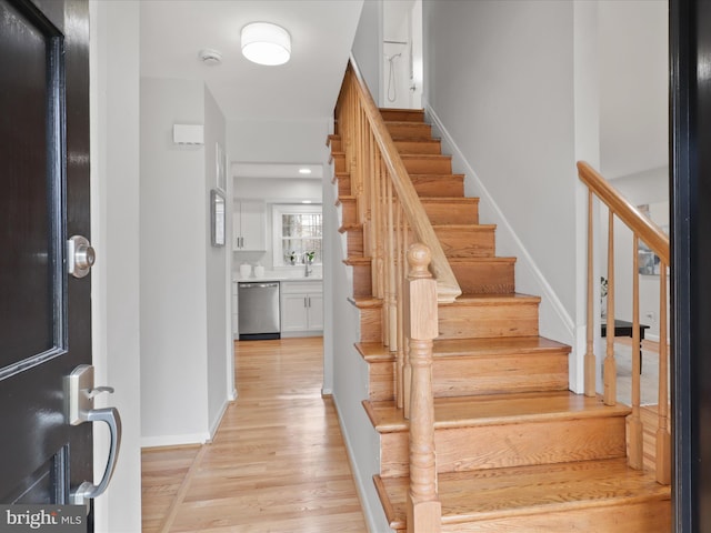 interior space featuring baseboards and wood finished floors