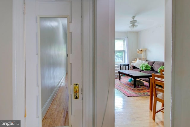 hallway with light hardwood / wood-style floors