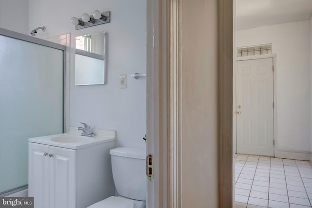 bathroom featuring vanity, toilet, tile patterned floors, and an enclosed shower