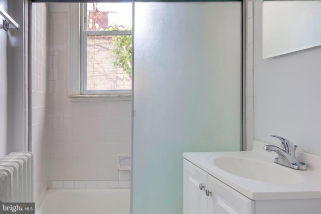 bathroom with vanity, separate shower and tub, and radiator heating unit