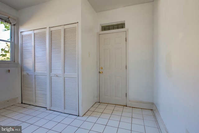 doorway to outside with light tile patterned floors