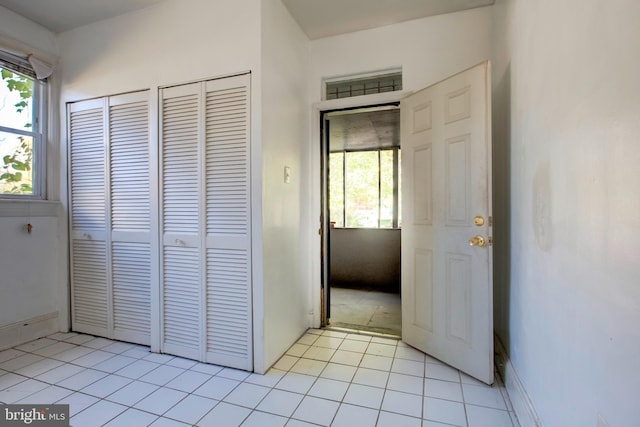 hallway featuring light tile patterned floors