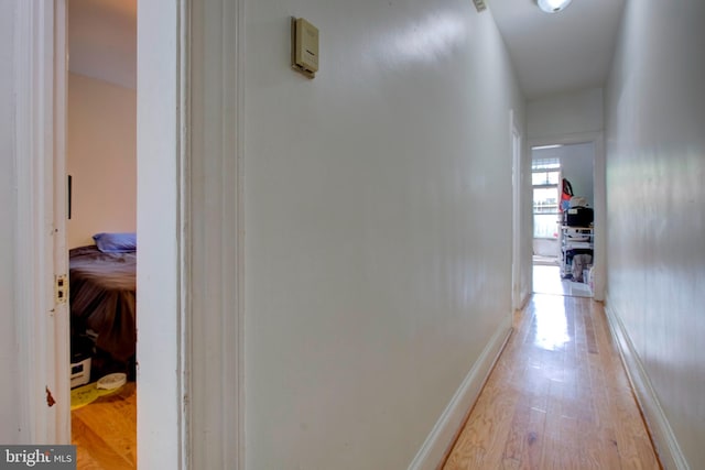 corridor with light wood-type flooring