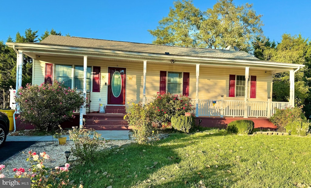 view of front of home with a front yard and a porch