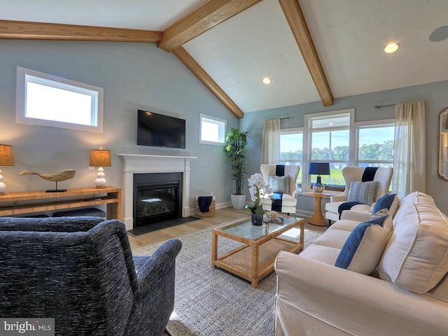 living room with high vaulted ceiling, light hardwood / wood-style floors, and beamed ceiling