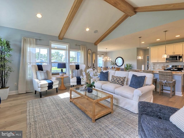 living room featuring high vaulted ceiling, an inviting chandelier, light hardwood / wood-style floors, and beam ceiling