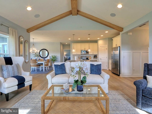 living room with high vaulted ceiling, light wood-type flooring, a notable chandelier, and beamed ceiling