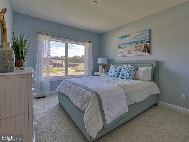 bedroom with light colored carpet