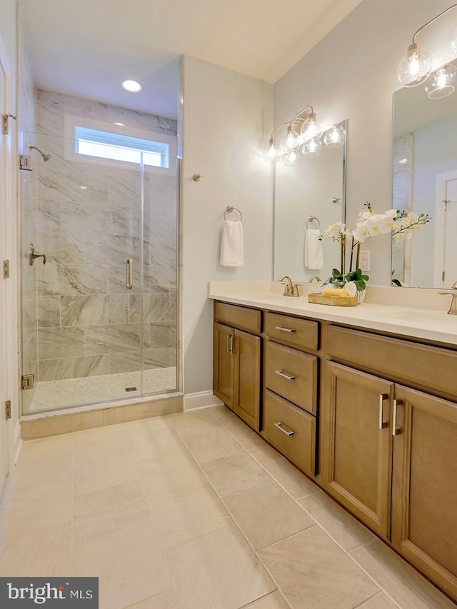 bathroom with an enclosed shower, vanity, and tile patterned floors