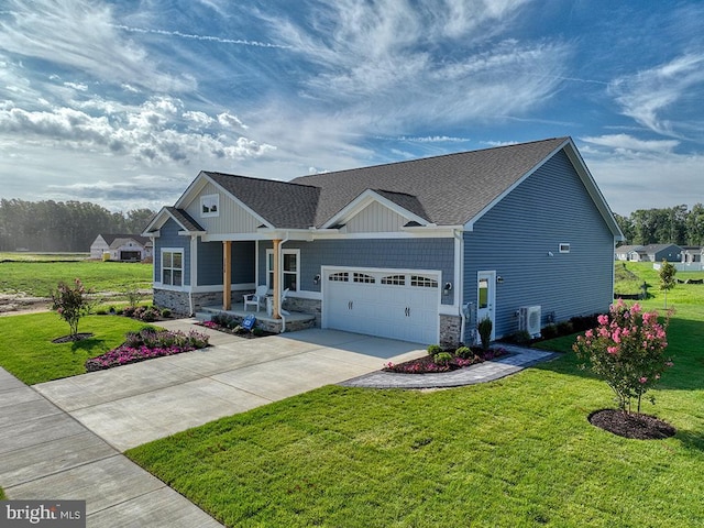 craftsman-style house featuring central air condition unit, a garage, and a front yard