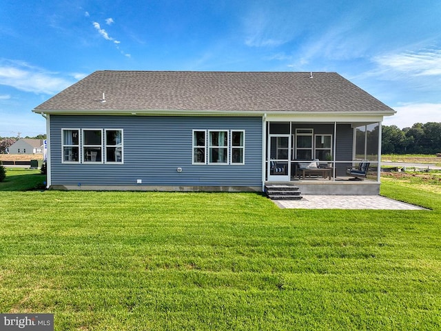 back of house with a lawn, a sunroom, and a patio area