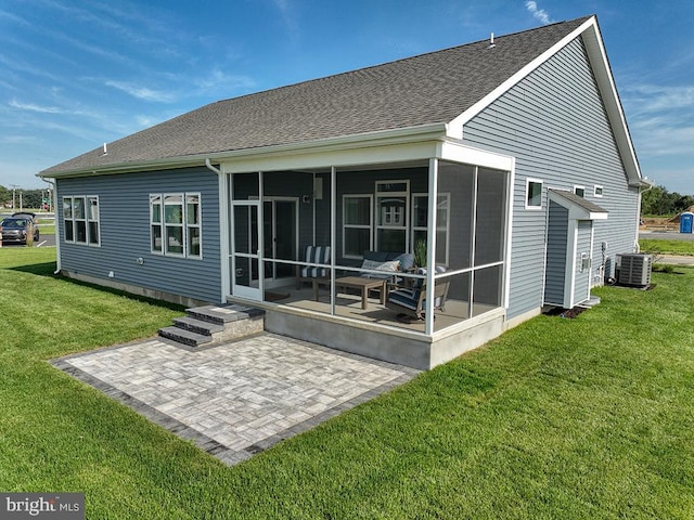 back of house with central air condition unit, a patio, a sunroom, and a yard