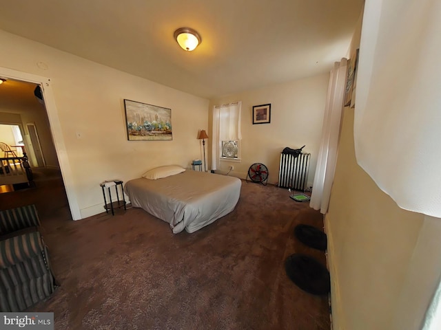 carpeted bedroom featuring radiator