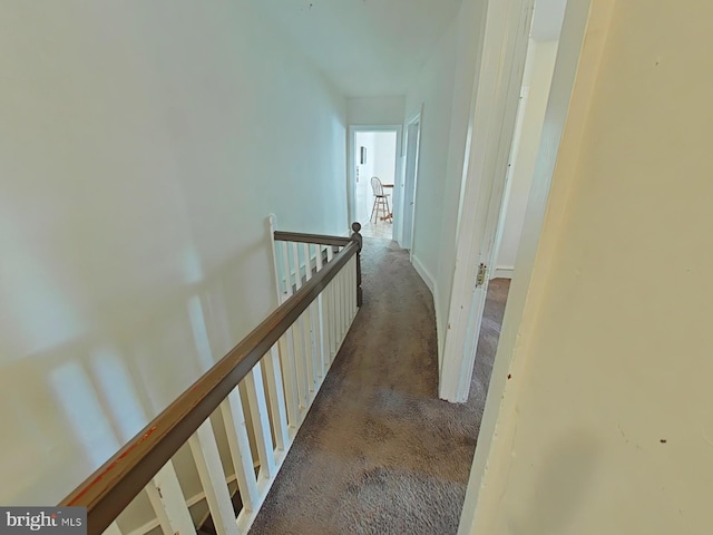 corridor with dark colored carpet