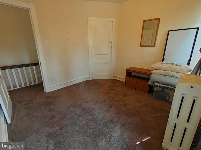 unfurnished bedroom featuring dark colored carpet