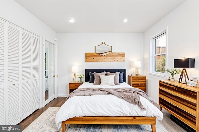 bedroom featuring a closet and dark hardwood / wood-style flooring