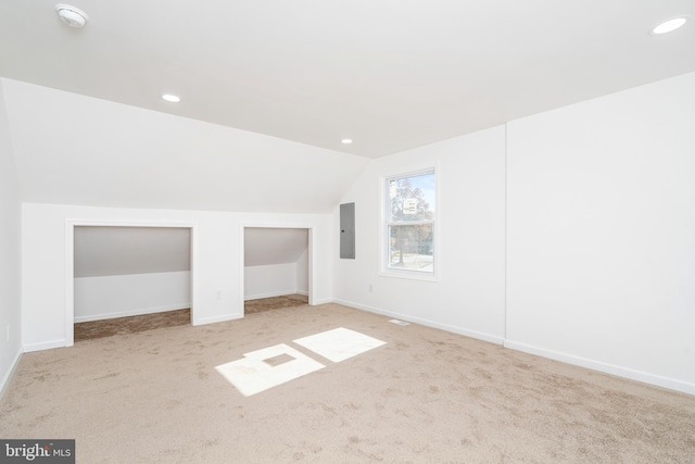 bonus room with light carpet and lofted ceiling