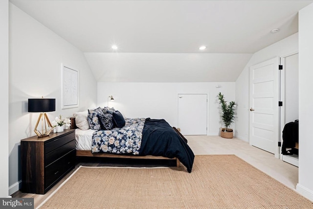 bedroom with light carpet and vaulted ceiling