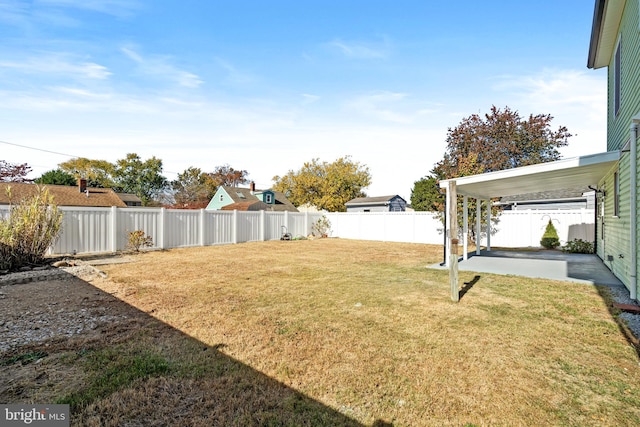 view of yard with a patio area and a carport