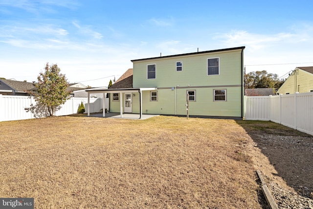 back of property with a patio and a lawn