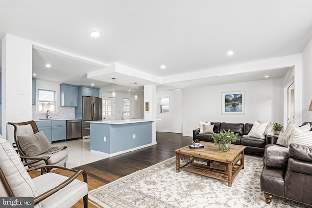 living room with sink and light hardwood / wood-style flooring