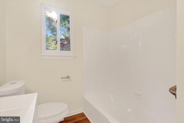 bathroom featuring hardwood / wood-style floors and toilet