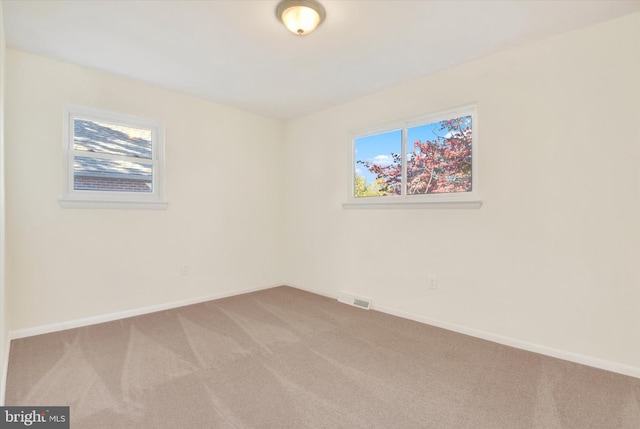 unfurnished room with carpet floors