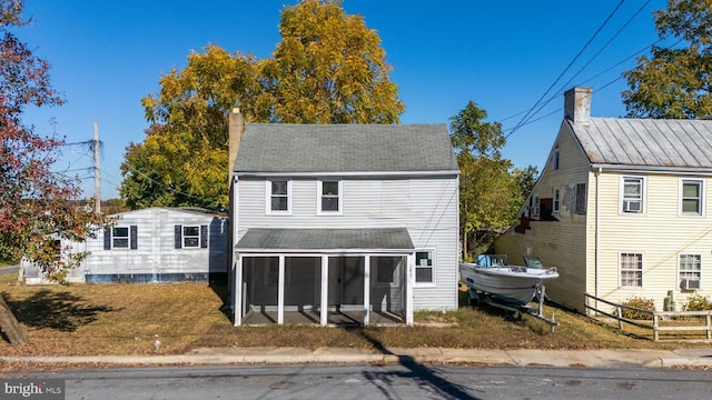 view of front of home with a sunroom