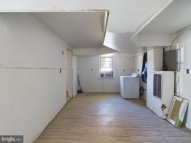 laundry area with washer / dryer and light wood-type flooring