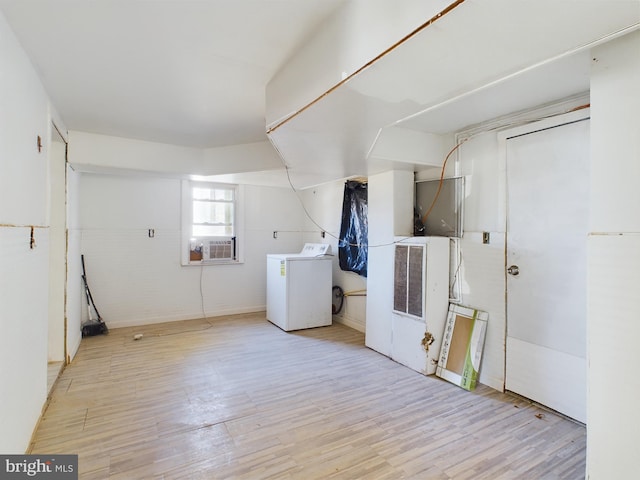 clothes washing area featuring light hardwood / wood-style floors, cooling unit, and washing machine and dryer