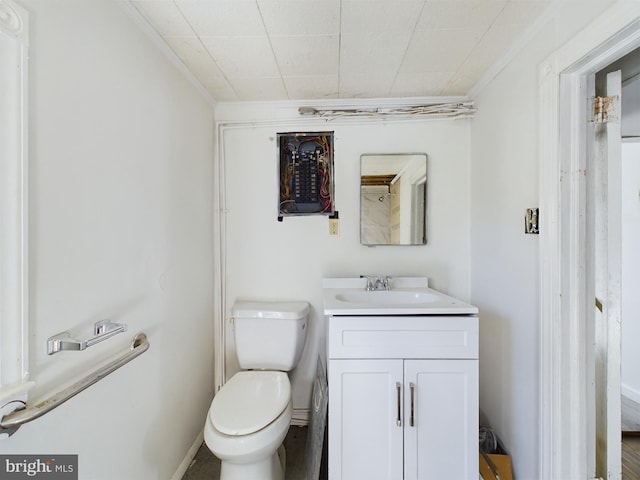 bathroom featuring vanity, crown molding, and toilet