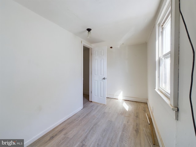 spare room with light hardwood / wood-style flooring