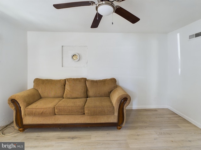 living room featuring light hardwood / wood-style flooring and ceiling fan