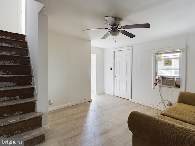 interior space with light hardwood / wood-style floors, cooling unit, and ceiling fan