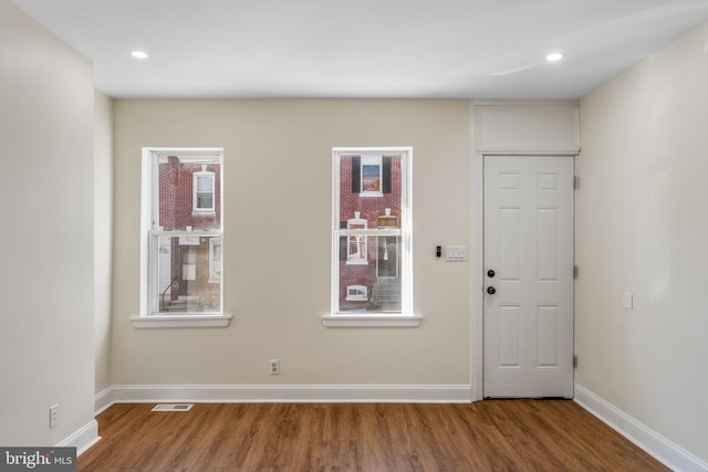 entryway with hardwood / wood-style floors and a healthy amount of sunlight