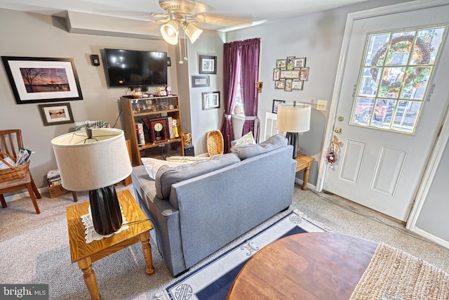 living room featuring carpet and ceiling fan