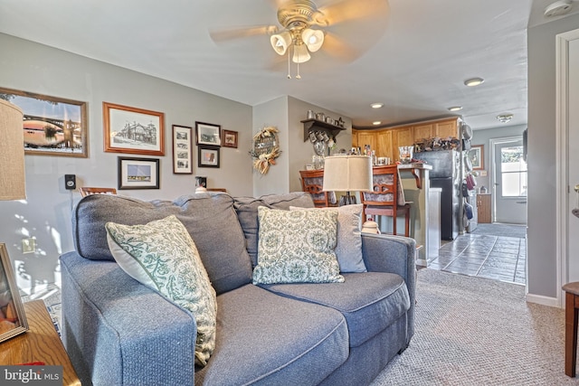 carpeted living room featuring ceiling fan