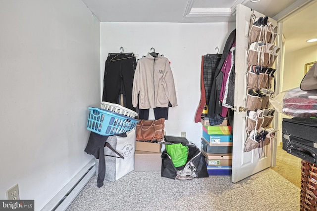 spacious closet featuring a baseboard radiator and carpet