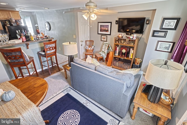 living room with wood-type flooring and ceiling fan