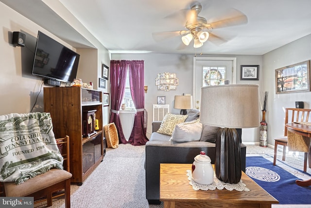 living room with ceiling fan and carpet flooring