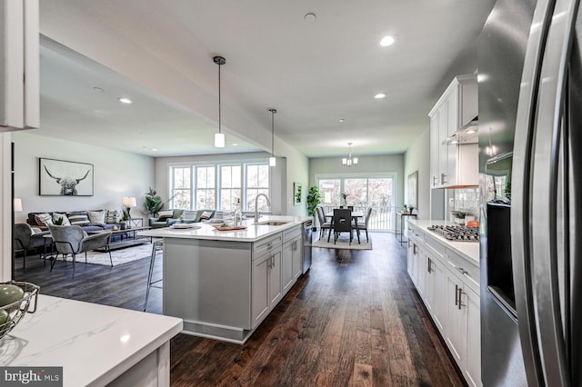 kitchen with sink, appliances with stainless steel finishes, a wealth of natural light, and white cabinetry