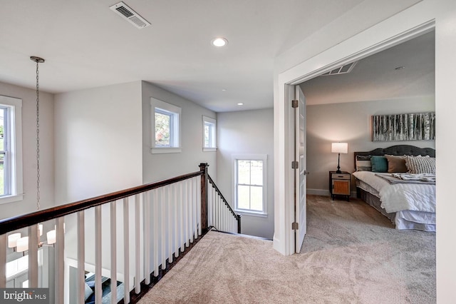 corridor with light colored carpet