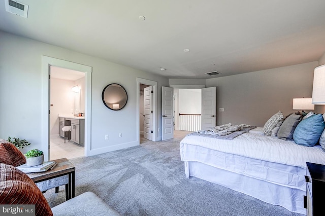 carpeted bedroom featuring ensuite bath