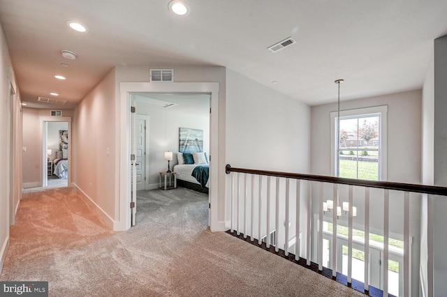 hallway with light colored carpet