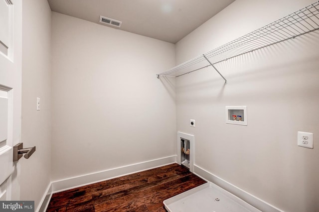 clothes washing area with dark wood-type flooring, electric dryer hookup, and washer hookup